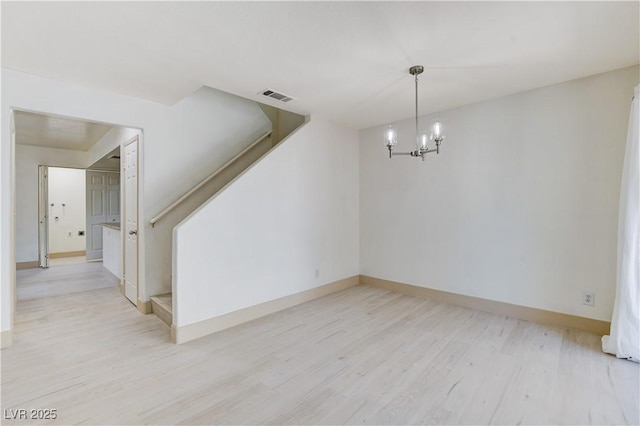 9409 Hershey Ln, Las Vegas, NV 89134 - unfurnished room with light wood-style floors, a chandelier, and stairs