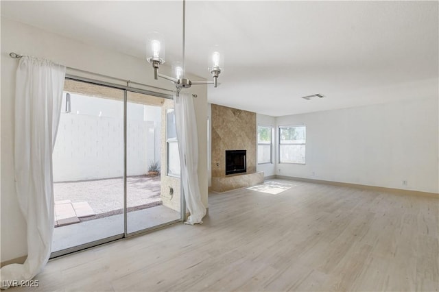 9409 Hershey Ln, Las Vegas, NV 89134 - unfurnished living room featuring wood finished floors, a chandelier, and a high end fireplace