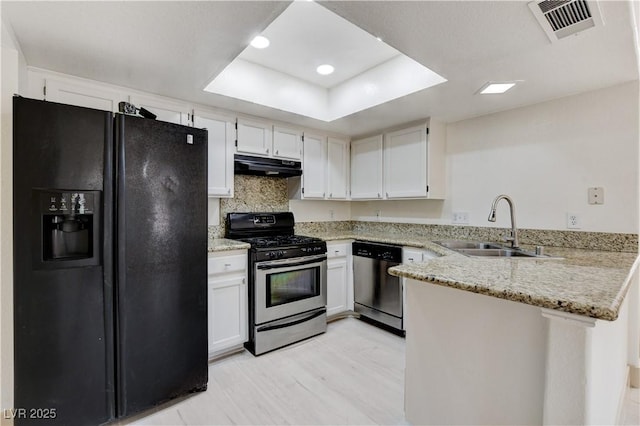 9409 Hershey Ln, Las Vegas, NV 89134 - kitchen featuring black fridge, dishwasher, gas stove, extractor fan, and a peninsula