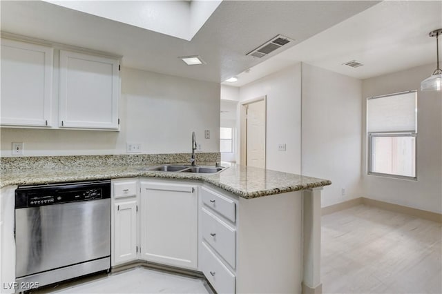 9409 Hershey Ln, Las Vegas, NV 89134 - kitchen with dishwasher, a peninsula, white cabinetry, and light stone counters