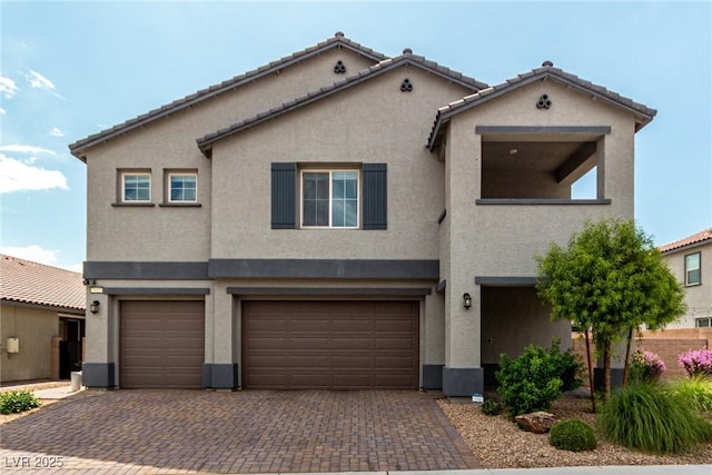 7615 Quail Dust St, North Las Vegas, NV 89084 - view of front of house featuring a garage, stucco siding, and decorative driveway