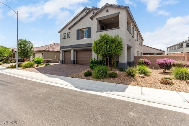 7615 Quail Dust St, North Las Vegas, NV 89084 - view of front facade with a garage, stucco siding, and decorative driveway