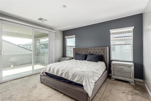 7615 Quail Dust St, North Las Vegas, NV 89084 - bedroom featuring light colored carpet, access to outside, and multiple windows