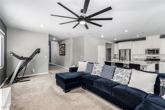 7615 Quail Dust St, North Las Vegas, NV 89084 - living room with light colored carpet, a ceiling fan, and recessed lighting