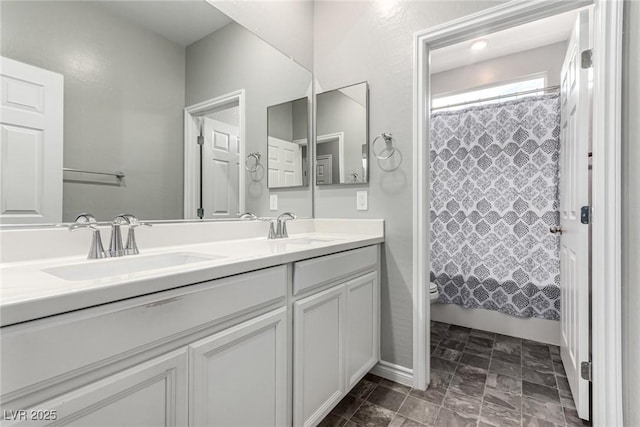 7615 Quail Dust St, North Las Vegas, NV 89084 - bathroom featuring double vanity and toilet