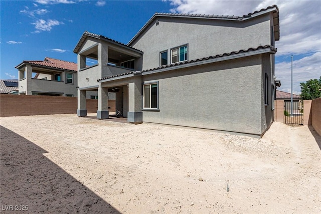 7615 Quail Dust St, North Las Vegas, NV 89084 - rear view of property with stucco siding, a fenced backyard, a balcony, a patio, and a tiled roof