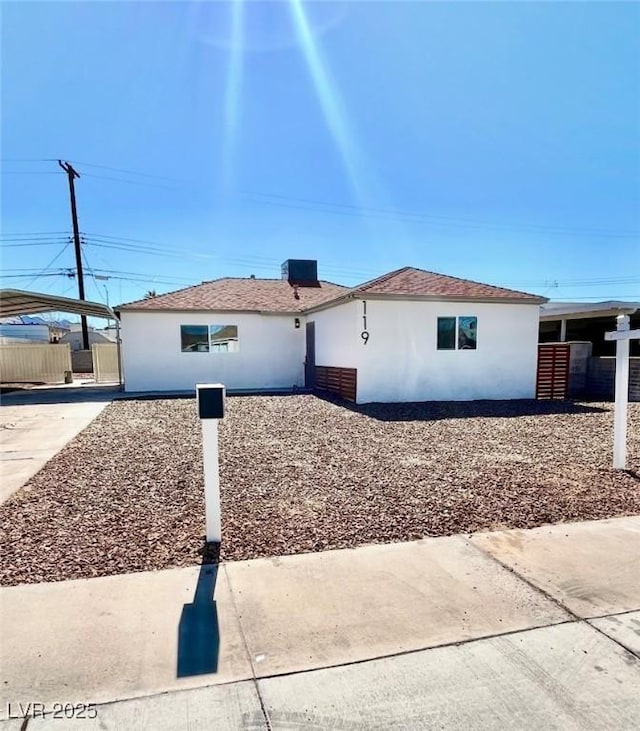 119 Cedar St, Henderson, NV 89015 - view of side of property with stucco siding and a detached carport