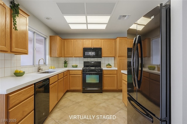 9325 Yucca Blossom Dr, Las Vegas, NV 89134 - kitchen featuring black appliances, decorative backsplash, light countertops, and light tile patterned flooring