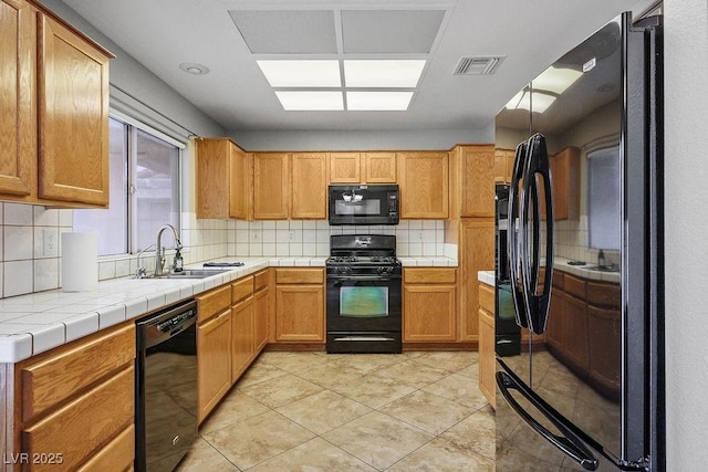 9325 Yucca Blossom Dr, Las Vegas, NV 89134 - kitchen featuring black appliances, tasteful backsplash, tile countertops, and light tile patterned floors