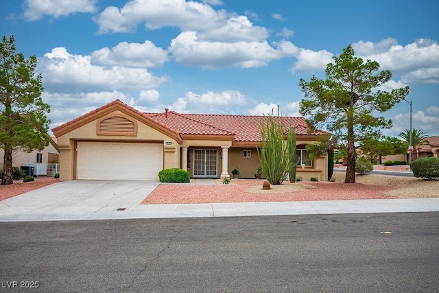 9325 Yucca Blossom Dr, Las Vegas, NV 89134 - mediterranean / spanish house with an attached garage, driveway, stucco siding, and a tile roof