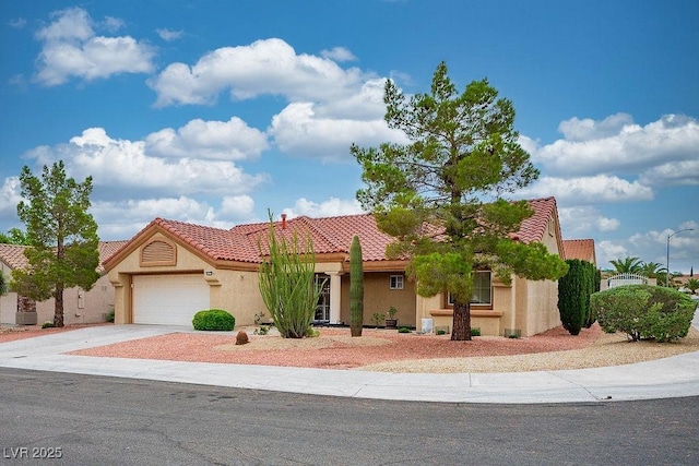 9325 Yucca Blossom Dr, Las Vegas, NV 89134 - view of front of property featuring stucco siding, an attached garage, a tiled roof, and concrete driveway