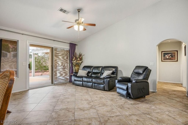 9325 Yucca Blossom Dr, Las Vegas, NV 89134 - living room featuring arched walkways, a ceiling fan, light tile patterned floors, and high vaulted ceiling