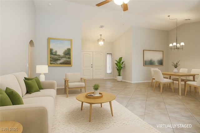 9325 Yucca Blossom Dr, Las Vegas, NV 89134 - living area with light tile patterned floors, a chandelier, a ceiling fan, arched walkways, and high vaulted ceiling