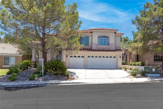 24 Staghorn St, Henderson, NV 89012 - mediterranean / spanish-style home with a garage, concrete driveway, stucco siding, and a tiled roof