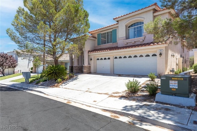 24 Staghorn St, Henderson, NV 89012 - mediterranean / spanish-style home with a tile roof, stucco siding, a garage, and driveway