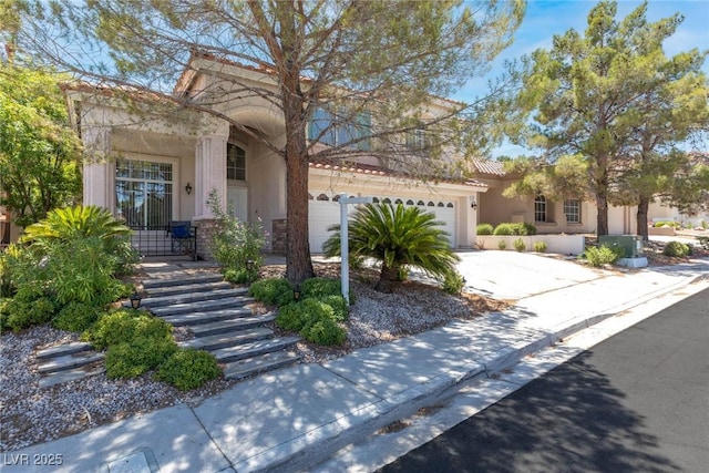 24 Staghorn St, Henderson, NV 89012 - view of front of house with stucco siding, concrete driveway, and an attached garage