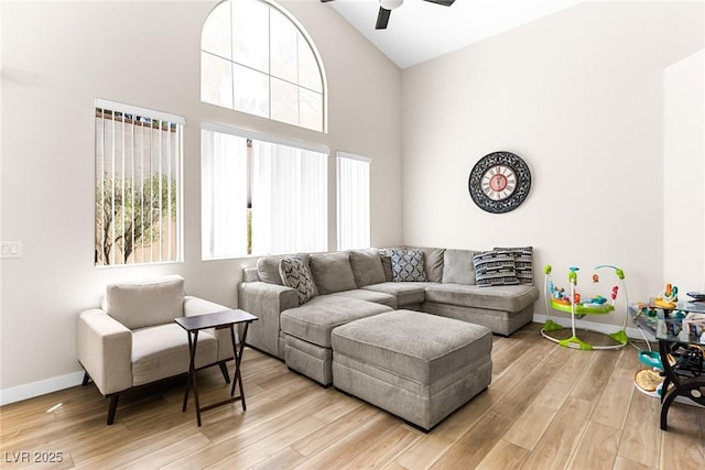 24 Staghorn St, Henderson, NV 89012 - living room with ceiling fan, light wood-style floors, and high vaulted ceiling