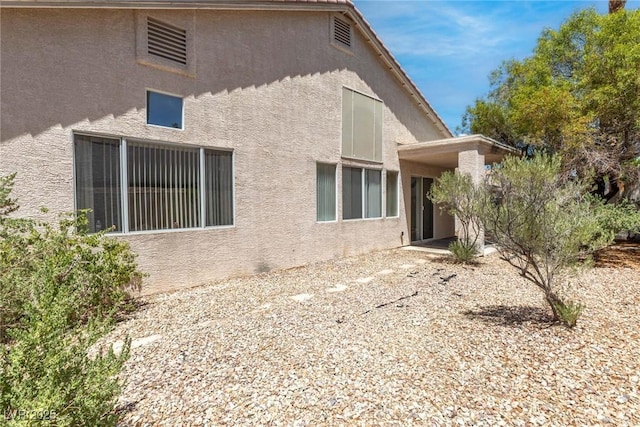 24 Staghorn St, Henderson, NV 89012 - rear view of property featuring stucco siding