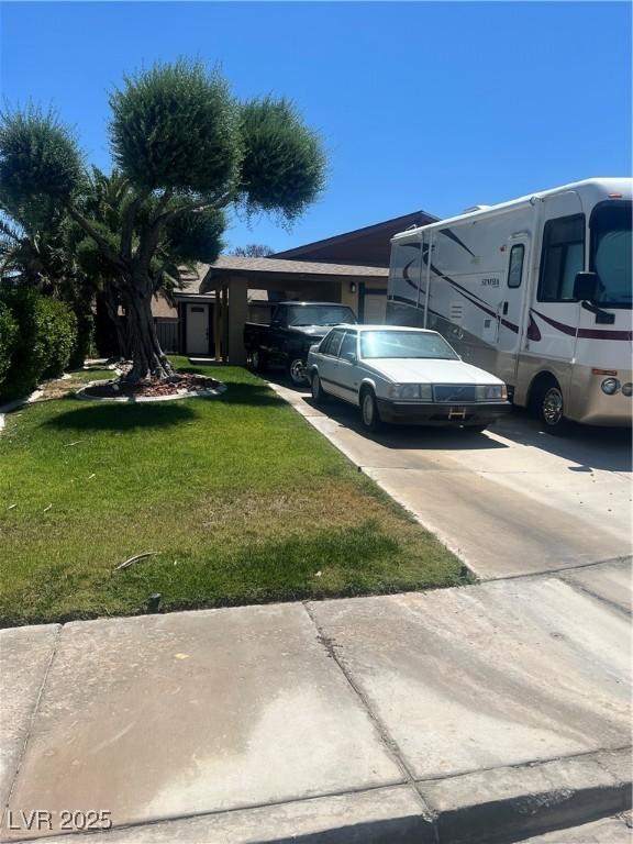 7247 Manatee Ct, Las Vegas, NV 89147 - view of grassy yard featuring driveway
