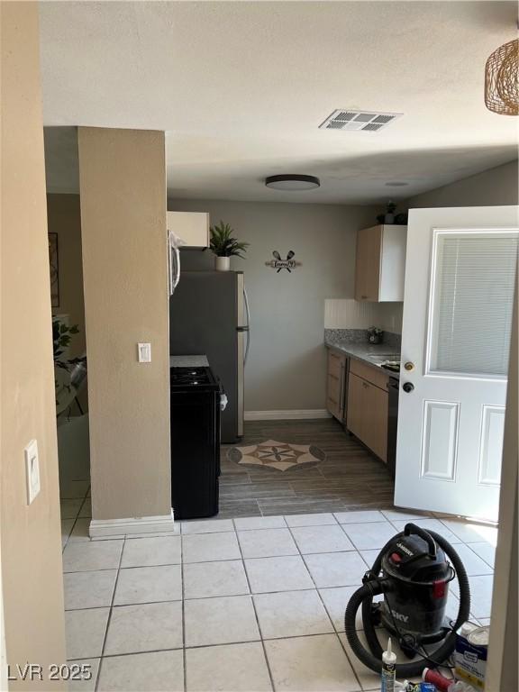 7247 Manatee Ct, Las Vegas, NV 89147 - kitchen with light tile patterned flooring and appliances with stainless steel finishes