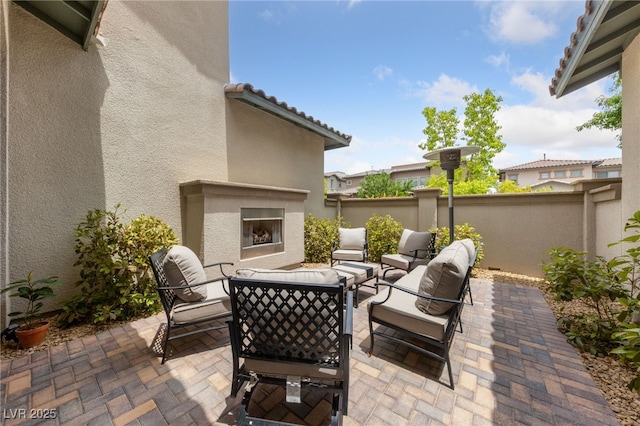367 Pollino Peaks St, Las Vegas, NV 89138 - view of patio / terrace with an outdoor living space with a fireplace