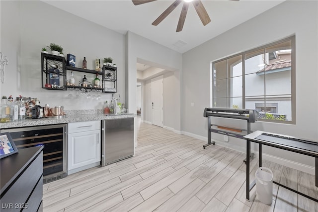367 Pollino Peaks St, Las Vegas, NV 89138 - indoor bar with refrigerator, wine cooler, a ceiling fan, and light wood-style flooring