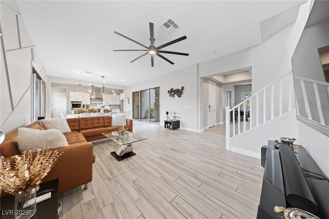 367 Pollino Peaks St, Las Vegas, NV 89138 - living area featuring ceiling fan, stairway, light wood-style floors, and a chandelier