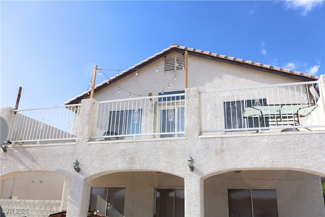 4525 Ranch Foreman Rd, North Las Vegas, NV 89032 - rear view of property featuring a balcony and stucco siding