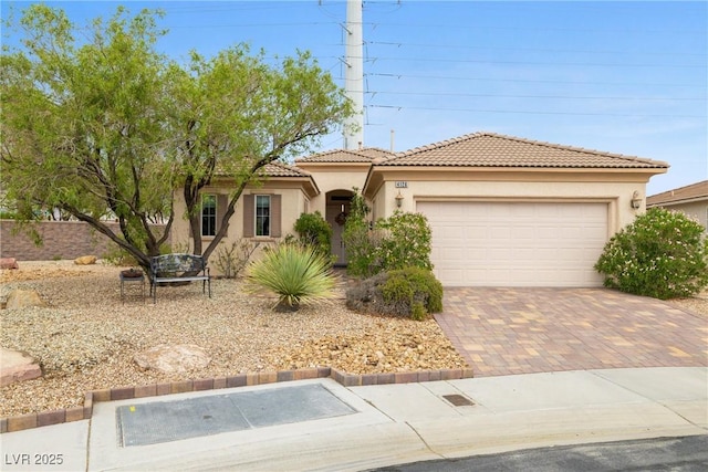 4126 Cascada Piazza Ln, Las Vegas, NV 89135 - mediterranean / spanish-style home with an attached garage, a tile roof, stucco siding, and decorative driveway