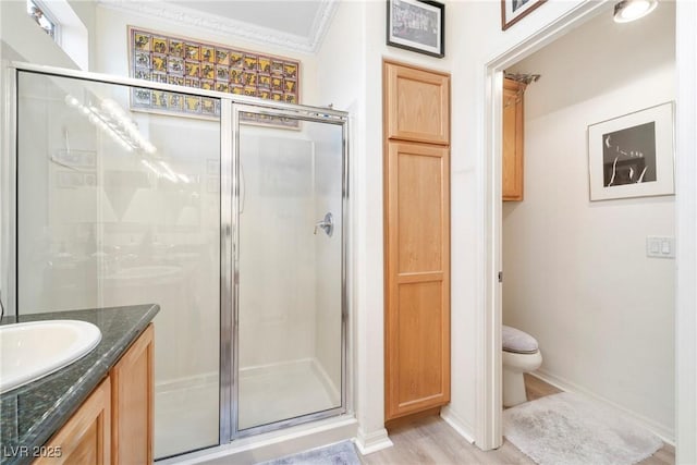 4126 Cascada Piazza Ln, Las Vegas, NV 89135 - full bathroom featuring a stall shower, vanity, ornamental molding, and wood finished floors