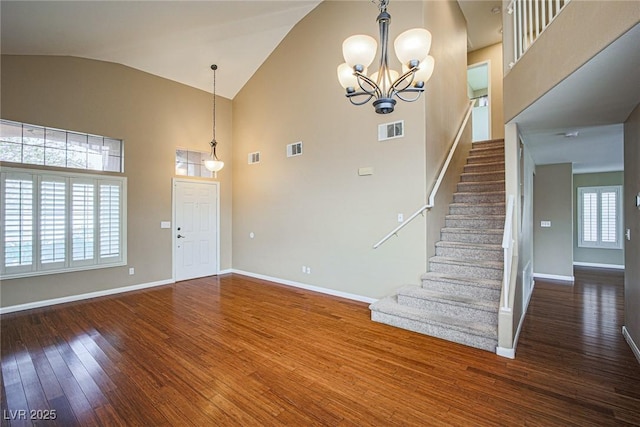 10204 Waseca Ave, Las Vegas, NV 89144 - foyer entrance featuring wood-type flooring, stairway, high vaulted ceiling, and a chandelier