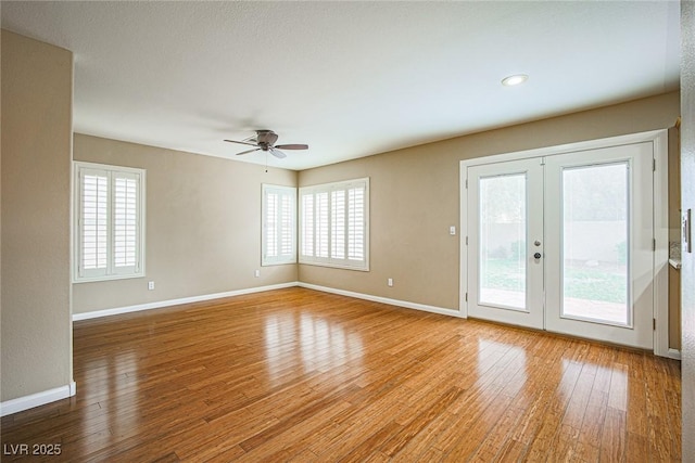 10204 Waseca Ave, Las Vegas, NV 89144 - empty room with healthy amount of natural light, a ceiling fan, wood finished floors, and french doors