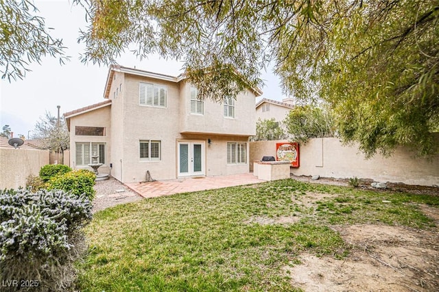 10204 Waseca Ave, Las Vegas, NV 89144 - rear view of property featuring french doors, a patio, a fenced backyard, and stucco siding