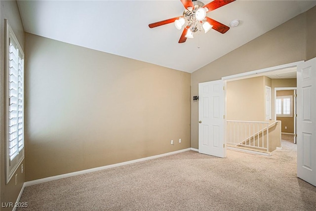10204 Waseca Ave, Las Vegas, NV 89144 - unfurnished room with light colored carpet, ceiling fan, vaulted ceiling, and a smoke detector