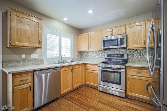 10204 Waseca Ave, Las Vegas, NV 89144 - kitchen featuring stainless steel appliances, light countertops, dark wood-type flooring, backsplash, and recessed lighting