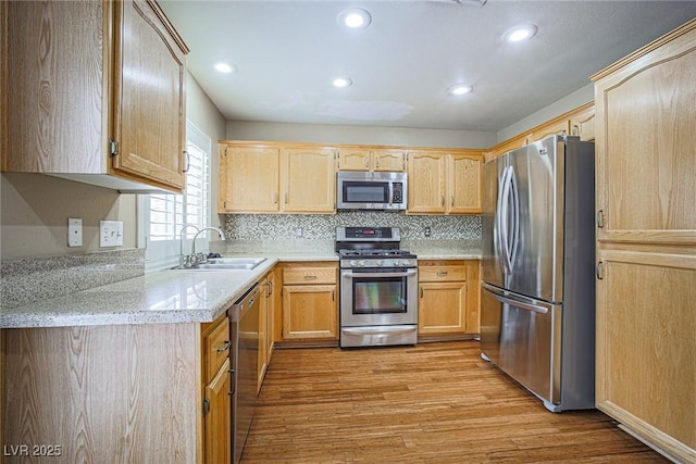 10204 Waseca Ave, Las Vegas, NV 89144 - kitchen with stainless steel appliances, light wood-style floors, recessed lighting, tasteful backsplash, and light brown cabinetry