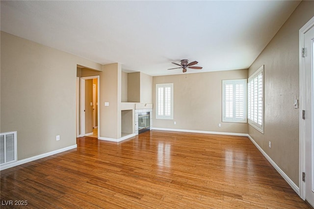 10204 Waseca Ave, Las Vegas, NV 89144 - unfurnished living room with ceiling fan, light wood finished floors, and a tiled fireplace