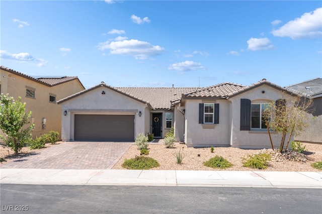 6209 Gambetta St, Las Vegas, NV 89115 - mediterranean / spanish-style house featuring stucco siding, decorative driveway, a tile roof, and a garage