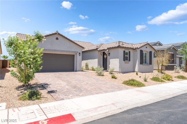 6209 Gambetta St, Las Vegas, NV 89115 - mediterranean / spanish-style house featuring stucco siding, a tile roof, decorative driveway, and a garage