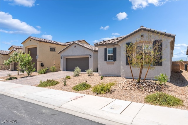 6209 Gambetta St, Las Vegas, NV 89115 - mediterranean / spanish-style home featuring stucco siding, a garage, driveway, and a tiled roof