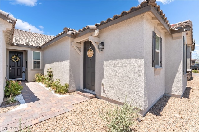 6209 Gambetta St, Las Vegas, NV 89115 - property entrance with stucco siding and a tile roof