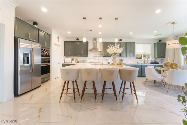 6209 Gambetta St, Las Vegas, NV 89115 - kitchen with appliances with stainless steel finishes, wall chimney exhaust hood, tasteful backsplash, light countertops, and a kitchen breakfast bar