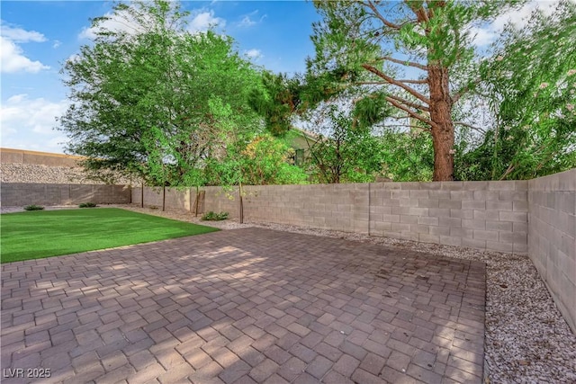 9089 Harvest Season Ct, Henderson, NV 89074 - fenced backyard featuring a patio area