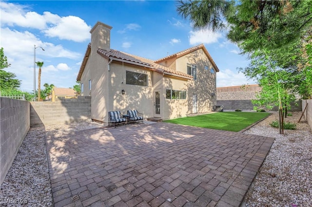 9089 Harvest Season Ct, Henderson, NV 89074 - back of house with a fenced backyard, stucco siding, and a patio
