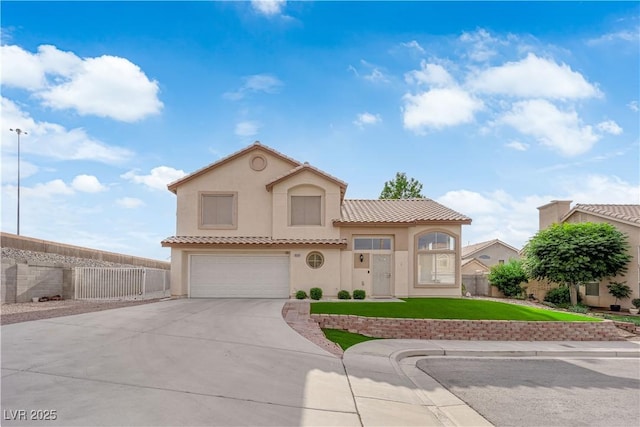 9089 Harvest Season Ct, Henderson, NV 89074 - mediterranean / spanish-style home featuring an attached garage, stucco siding, driveway, and a tile roof