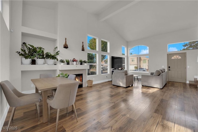 9089 Harvest Season Ct, Henderson, NV 89074 - dining room with high vaulted ceiling, beamed ceiling, wood finished floors, and a fireplace