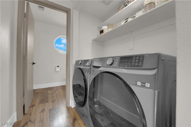 9089 Harvest Season Ct, Henderson, NV 89074 - laundry area featuring washer and dryer and wood finished floors