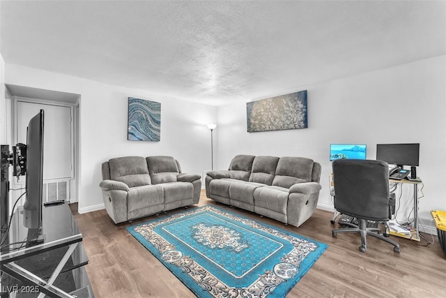 1405 Vegas Valley Dr Unit 347, Las Vegas, NV 89169 - living room featuring a textured ceiling and wood finished floors