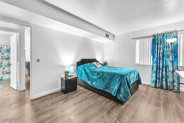 1405 Vegas Valley Dr Unit 347, Las Vegas, NV 89169 - bedroom with wood finished floors and a textured ceiling