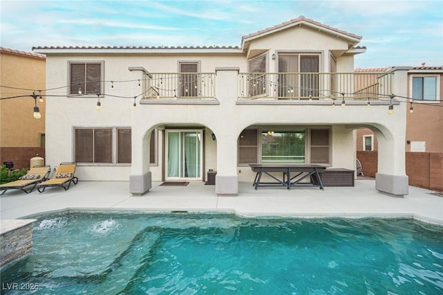 6937 Puetollano Dr, North Las Vegas, NV 89084 - back of house featuring a balcony, a patio area, and stucco siding